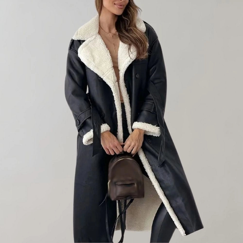 Luxury women's black leather coat with shearling lining featuring a knee-length design, tailored waist, and a cozy collar.