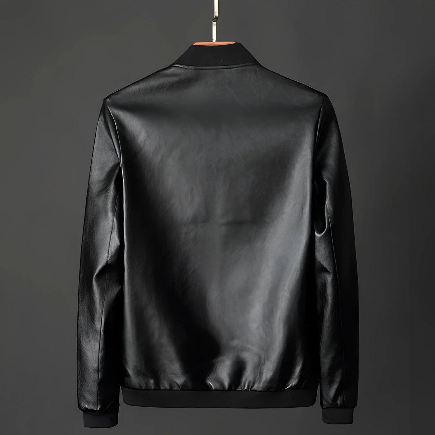 Men's classic black glossy leather jacket displayed on a clothes hanger, featuring a sleek design with a collar and long sleeves, ideal for luxury outerwear and formal wear occasions.