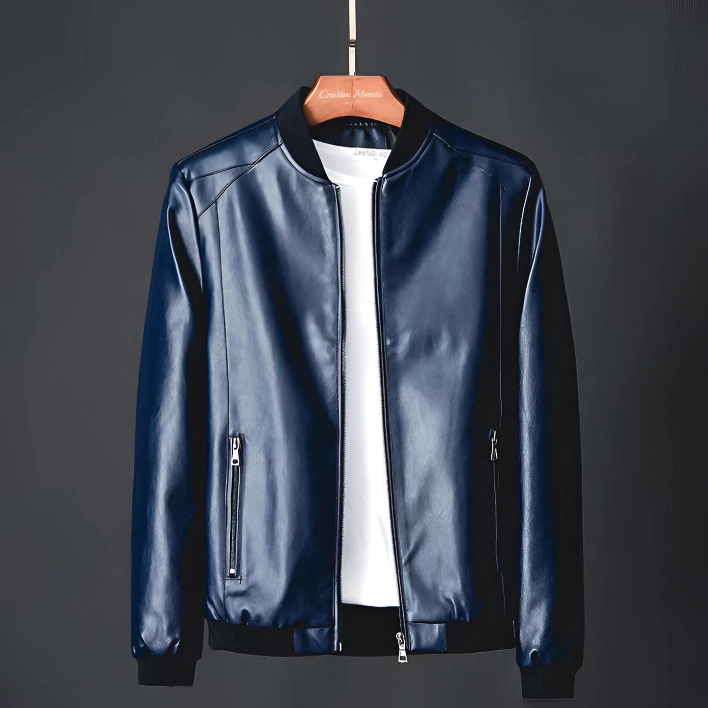 Men's glossy black leather jacket on a clothes hanger, featuring classic design with a structured collar, full-length sleeves, and formal styling suitable for luxury outerwear.