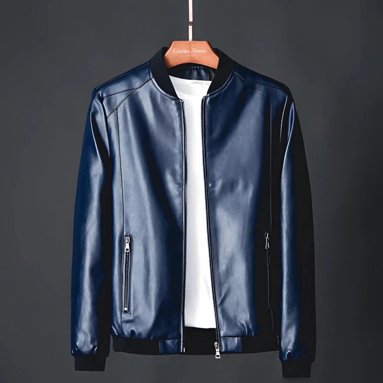 Men's glossy black leather jacket on a clothes hanger, featuring classic design with a structured collar, full-length sleeves, and formal styling suitable for luxury outerwear.
