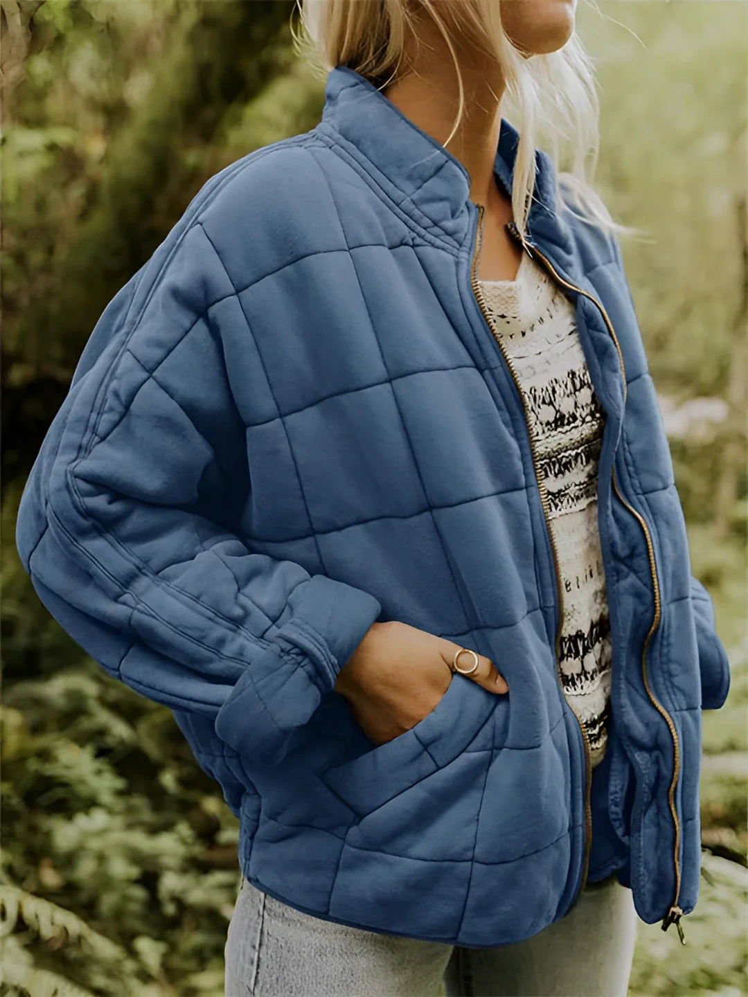 
A blue women's lightweight insulated quilted jacket in size 2XL, featuring a collar, long sleeves, and a waist-length design.