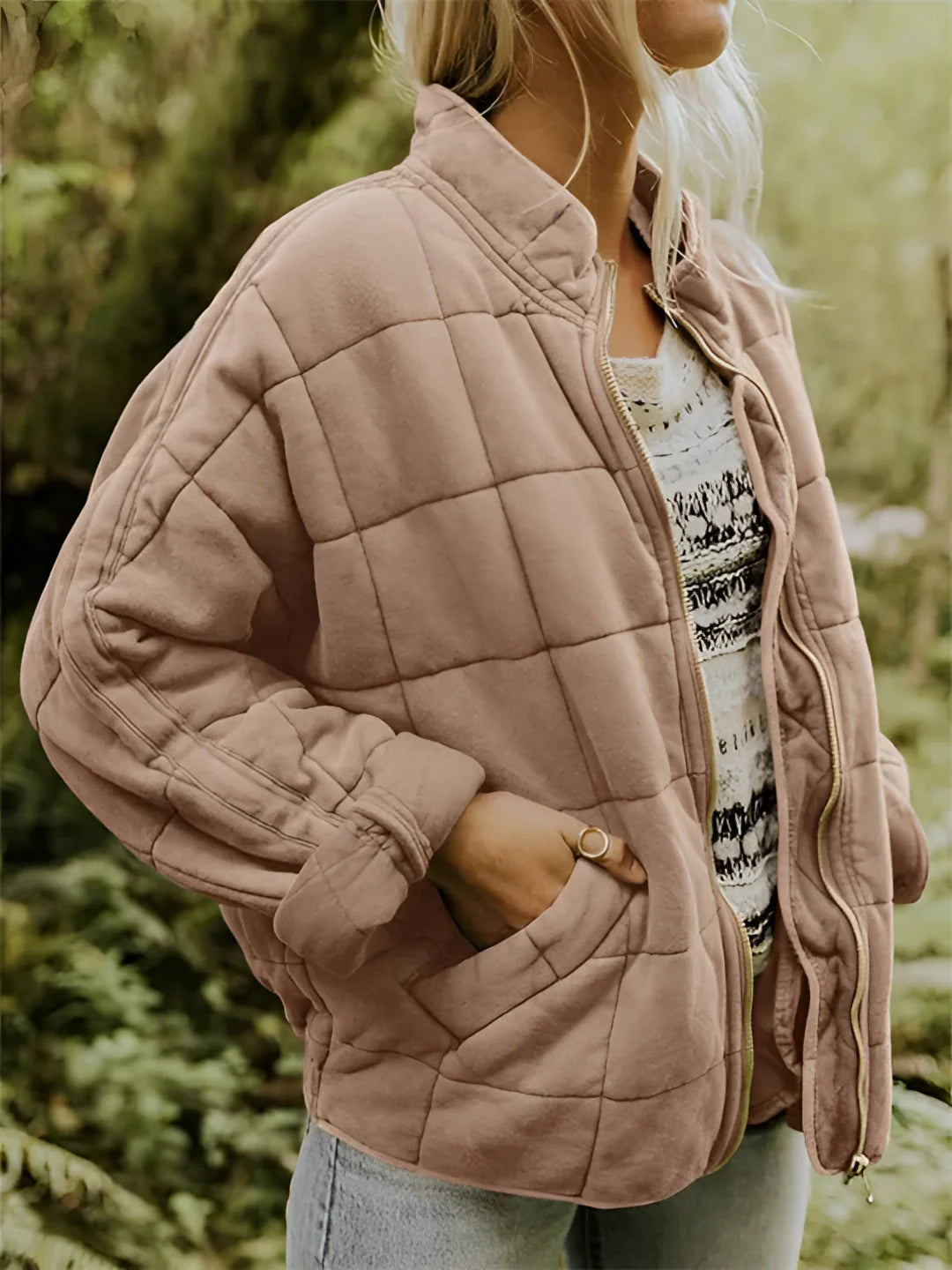 
A women's lightweight insulated forest green quilted jacket in khaki color, displayed in size 2XL. The jacket features a quilted pattern with a focus on outerwear elements such as a high neckline, long sleeves, and a fitted waist. It is made from natural materials and designed for comfort and style.