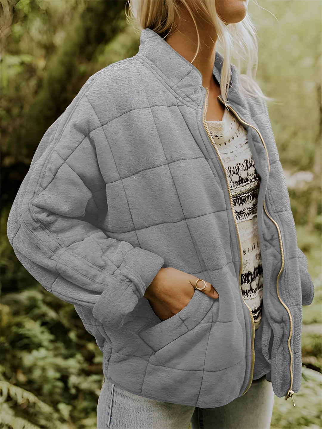 
A gray women's lightweight insulated quilted jacket in size 2XL, featuring a high collar, long sleeves, and a fitted waist.