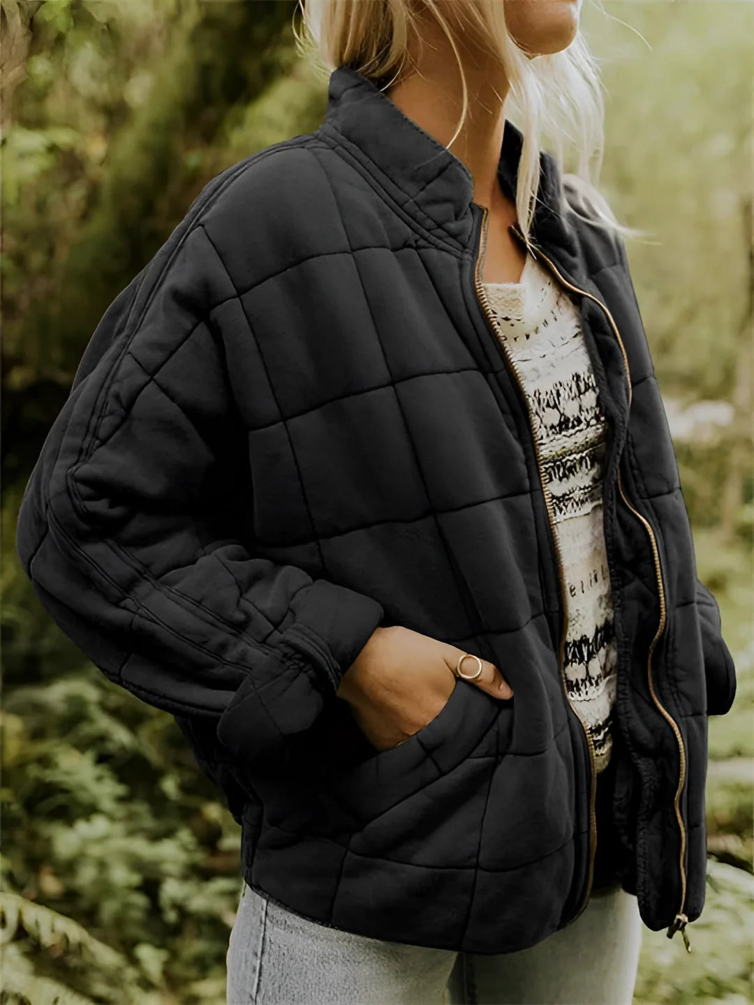 Women's lightweight insulated quilted jacket in a forest green color, featuring a sleek design with a collar and long sleeves. The jacket is displayed in a black color option, size 2XL, and has a quilted pattern that adds texture and style. The jacket is designed for comfort and warmth, suitable for cool weather.