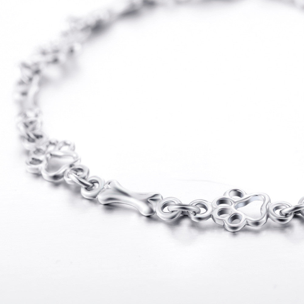 Zilveren armband met hondenpoot- en botbedeltje